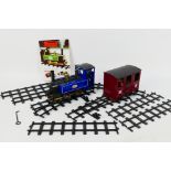 Mamod - A live steam loco in blue with Junior labels with a maroon carriage and 8 x pieces of track