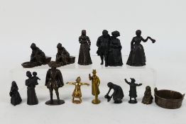 A collection of bronze figures to include Victorian style ladies, gentlemen, servants,