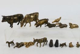 A collection of bronze figures of animals to include bull / cows, sheep, pigs, dogs,