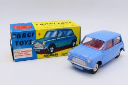 Corgi - A boxed Morris Mini Minor in blue with red interior and shaped wheel hubs # 226.