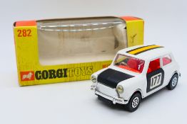 Corgi - A boxed Mini Cooper with whizzwheels in white and black with racing number 177 # 282.