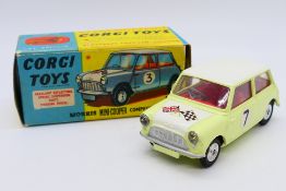 Corgi - A boxed Morris Mini Cooper Competition model in Primrose yellow with a white bonnet and