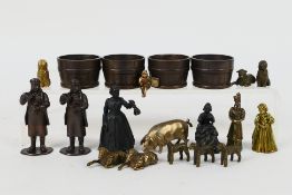 A collection of bronze figures to include Victorian style ladies, gentlemen, children, dogs,