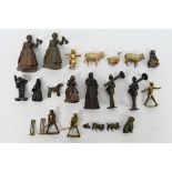 A collection of bronze figures to include Victorian style ladies, gentlemen, cricketers,