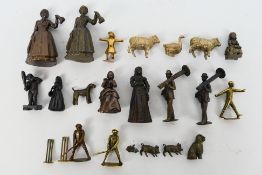 A collection of bronze figures to include Victorian style ladies, gentlemen, cricketers,