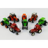 Britains - An unboxed collection of eight diecast model tractors from Britains.