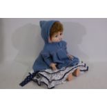 Roddy - A vintage Roddy doll standing 55 cm tall with dress and coat.