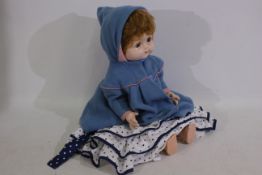 Roddy - A vintage Roddy doll standing 55 cm tall with dress and coat.
