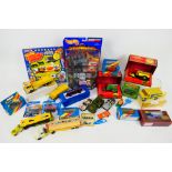 Matchbox - Hot Wheels - A boxed and unboxed group of diecast model vehicles in various scales.