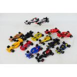 Scalextric - A grid of 14 unboxed playworn Scalextric Formula 1 / Formula 2 slot cars.