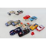 Scalextric - An unboxed group of 12 playworn Scalextric slot cars.