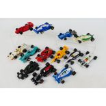 Scalextric - A grid of 13 unboxed playworn Scalextric Formula 1 / Formula 2 slot cars.