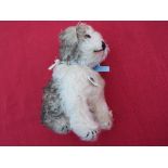 Steiff - Molly 1925 Replica Dog, seated, brown and white mohair, pale blue ribbon to the neck,