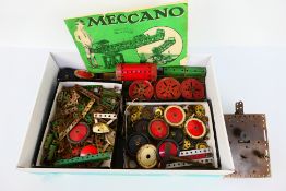 Meccano - A quantity of unboxed red and green vintage Meccano parts including sprockets, gears,