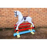 An unmarked children's rocking horse which measures approximately 90cms (H) x 92cms (L) x 36cms (D).