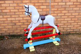 An unmarked children's rocking horse which measures approximately 90cms (H) x 92cms (L) x 36cms (D).