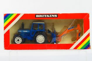 Britains - Farming. A boxed Britains #9598 1/32 scale Ford 7710 tractor and rear digger.