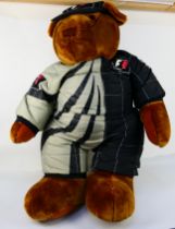 Formula 1 - A large free standing display model Teddy in Formula 1 race suit and cap.