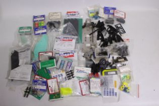 Kyosho - Tamiya - A quantity of mainly Kyosho and Tamiya spare parts suitable for RC car modelling.