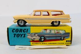 Corgi Toys - A boxed Corgi Toys #219 Plymouth Sports Suburban Station Wagon.