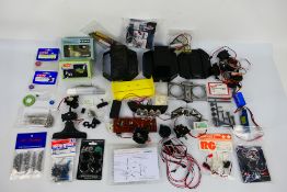 Kyosho - CEN - Others - A group of mainly loose RC car parts.