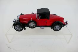 Franklin Mint - A boxed 1928 Stutz Boat-Tail Roadster in 1:24 scale.