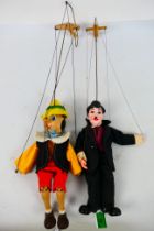 Unbranded - 2 x vintage marionettes, Charlie Chaplin and Pinocchio.