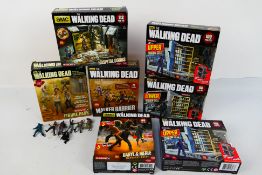 McFarlane - A boxed group of 7 McFarlane 'The Walking Dead' building sets and figures.