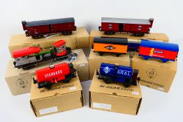 Paya - 7 x boxed modern tinplate wagons including McVities vans, a breakdown crane,