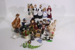 A collection of porcelain dolls house accessories, furniture and dolls to include chair, pram,