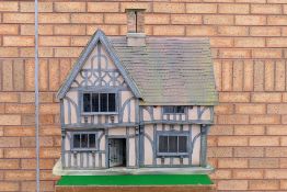 A Doll's House hand crafted by Robert Stubbs depicted a period timbered property with four rooms