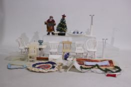 A collection of dolls house accessories and furniture to include chairs, table, ceramic tea set,