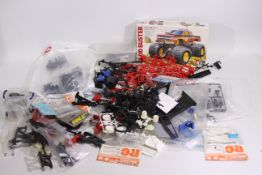 Tamiya - A box containing a large quantity of parts which appear to relate to various Tamiya RC