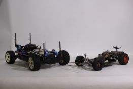 Kyosho - Two unboxed Kyosho chassis.