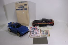 Tamiya - An unboxed vintage Tamiya 1:12 electric RC Porsche chassis with a boxed Tamiya #50306