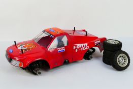 Kyosho - An unboxed and constructed Kyosho 1:10 scale nitro RC Exxon Ford F-150 Landmax 4WD .