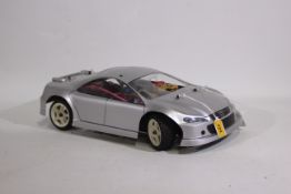 Kyosho - An unboxed Kyosho 1:10 scale nitro Mantis GPFF 2 speed chassis fitted with a 'Mazda' style