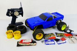 Kyosho - An unboxed Kyosho 1:10 scale nitro RC Buggy chassis with an unmarked custom body shell in