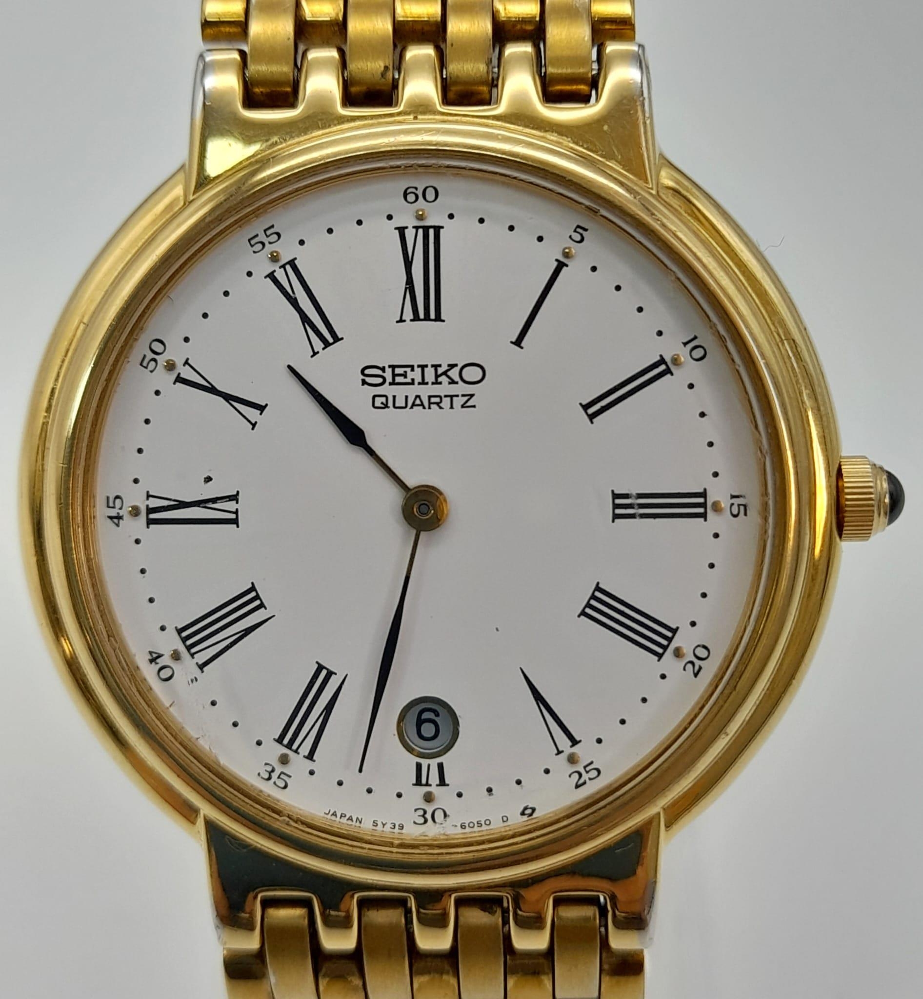 A Gilded Seiko Quartz Ladies Watch. Case -34mm. White dial with date window. In good condition and