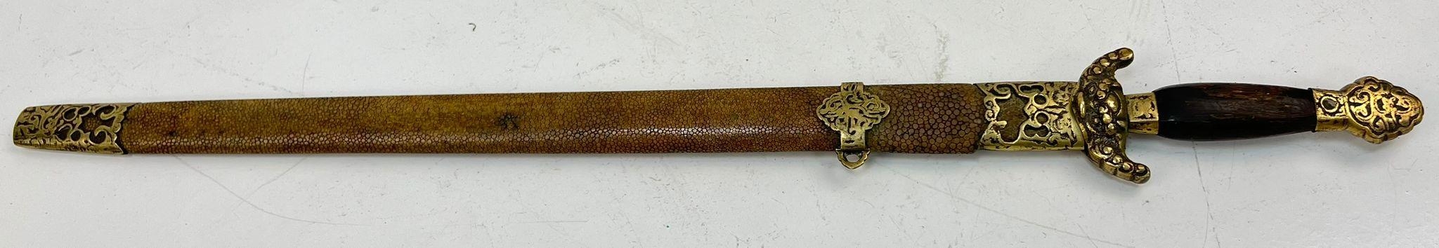 An Antique Short-Sword Possibly of Indian Origin. Snakeskin and brass scabbard. Decorated blade.