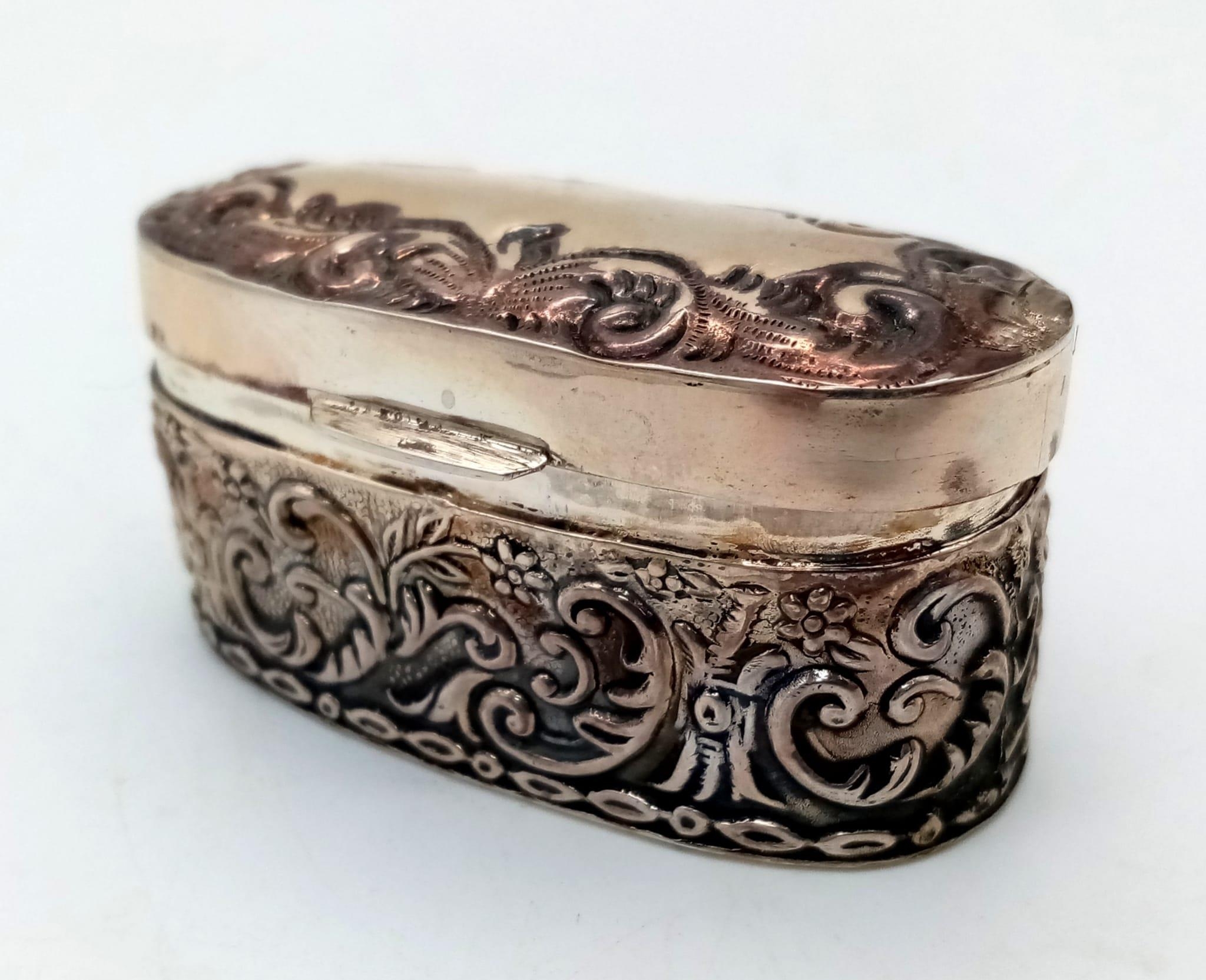 An Antique Silver Oval Trinket Box with Scrolled Decoration. 28g. 5 x 2.5cm. - Image 2 of 3