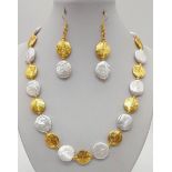 A rarely seen, coin shaped, large natural pearls and 18K yellow gold plated spacer beads in a