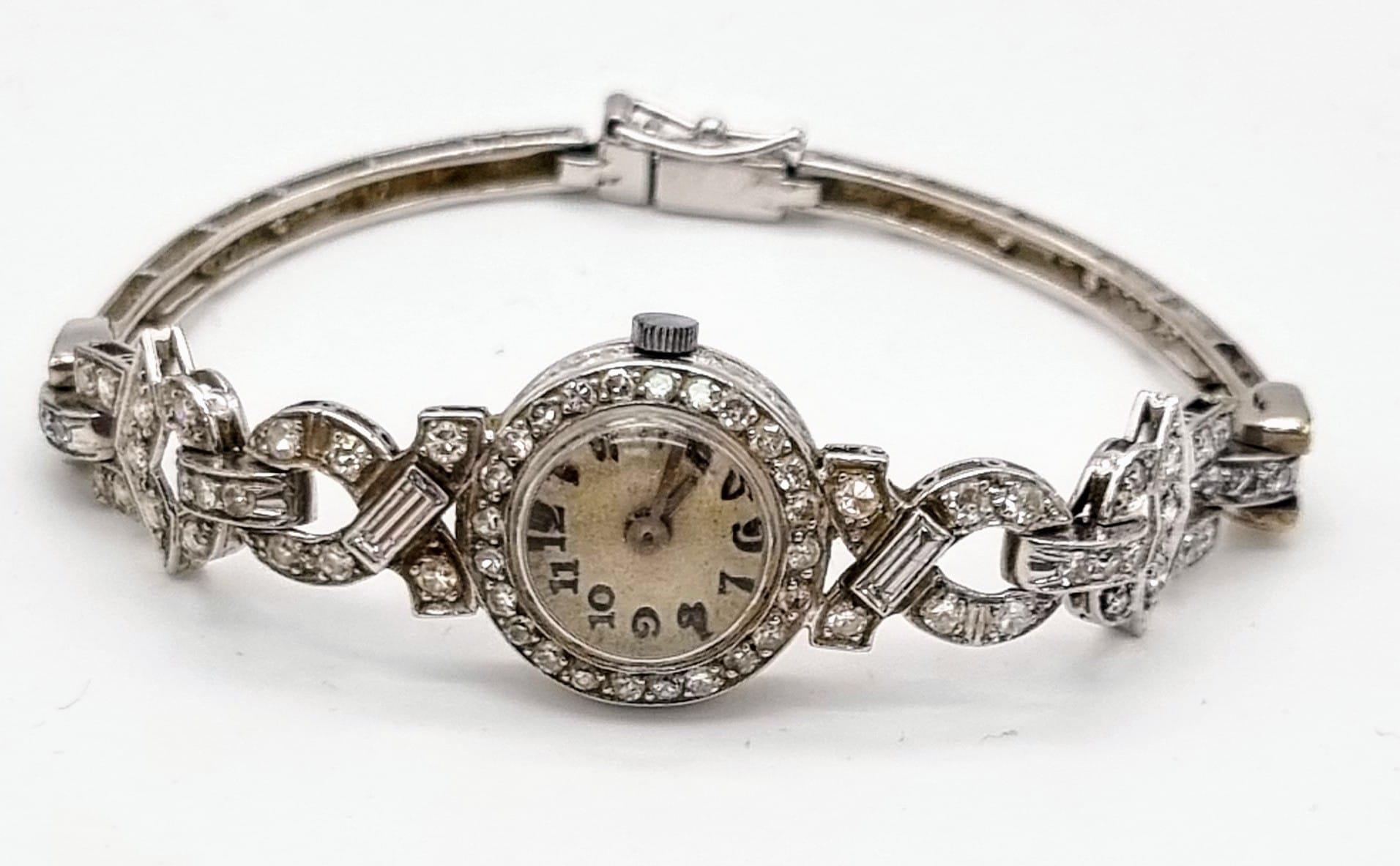 An Antique 14K White Gold and Diamond Ladies Watch. Art Deco Style with a gold and diamond bracelet.