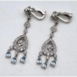 A Beautiful Pair of 18K White Gold, Diamond and Topaz Drop Earrings. A drop diamond teardrop with