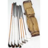 A VINTAGE GOLF BAG CONTAINING 8 CLUBS OF VARIOUS AGES INCLUDING 5 WOODEN AND HICKORY SHAFTED 2