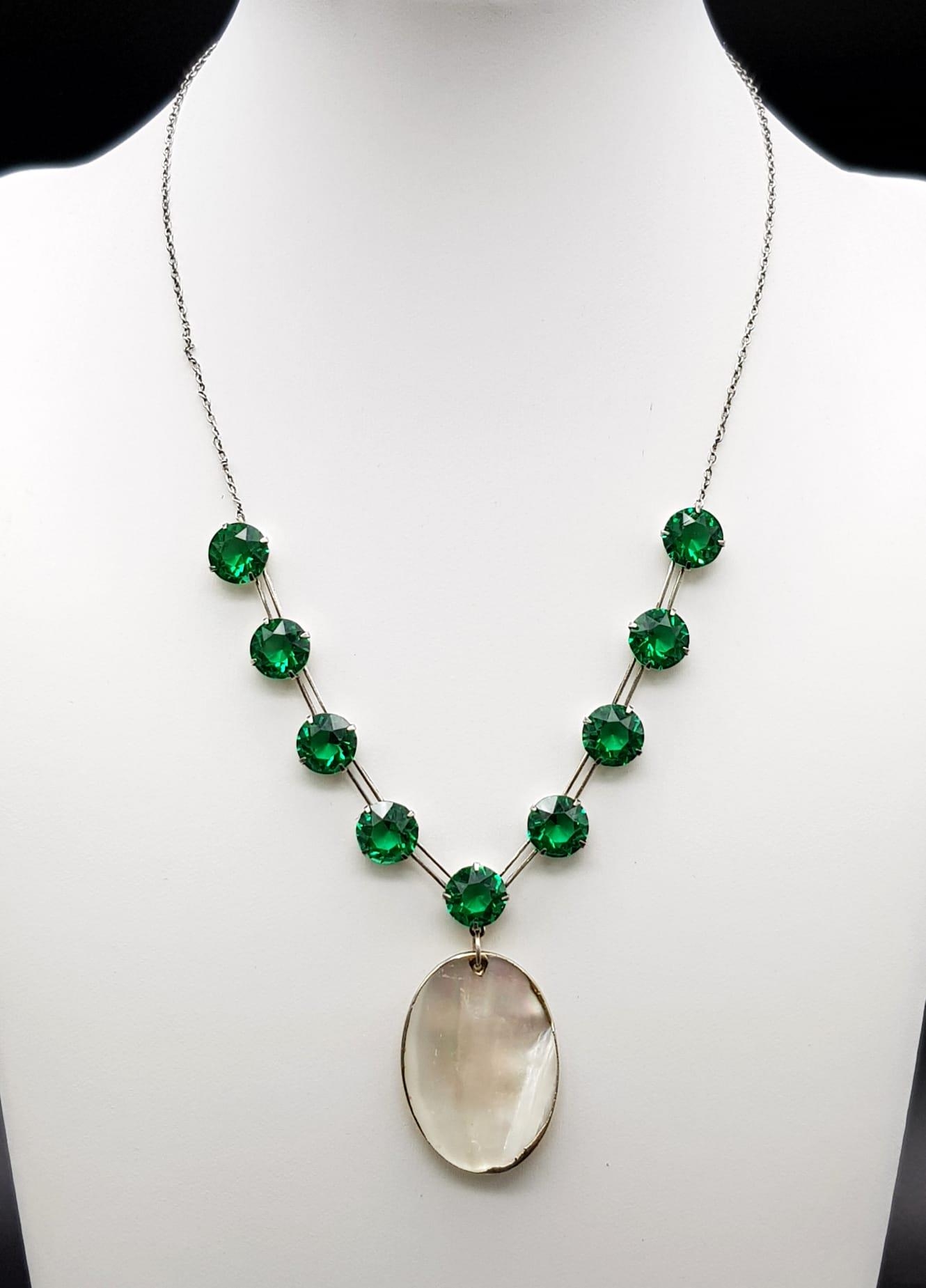 A MALACHITE AND MOTHER OF PEARL NECKLACE SET IN SILVER . 8.8gms 40cms