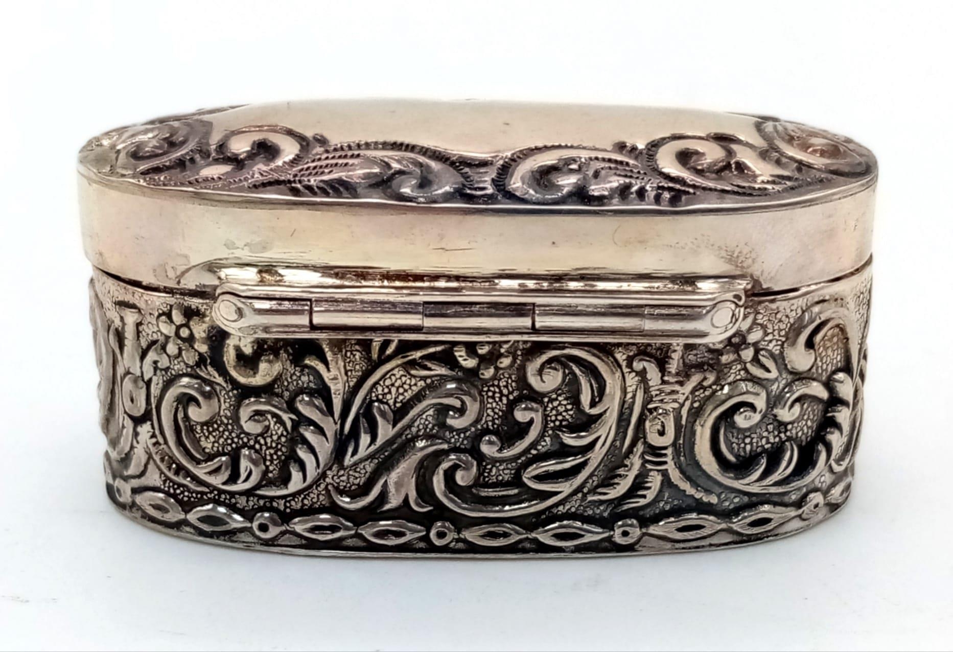 An Antique Silver Oval Trinket Box with Scrolled Decoration. 28g. 5 x 2.5cm. - Image 3 of 3