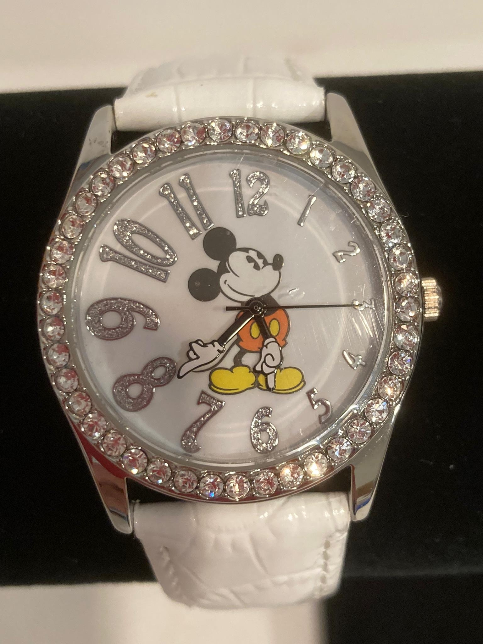 White face MICKEY MOUSE WRISTWATCH with jewelled bezel. Quartz movement .White leather strap. Full