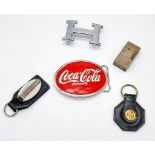 Two Belt Buckles, a Coca-Cola and a Hermes, two key chains, Maranello and MG Motors and a lighter.