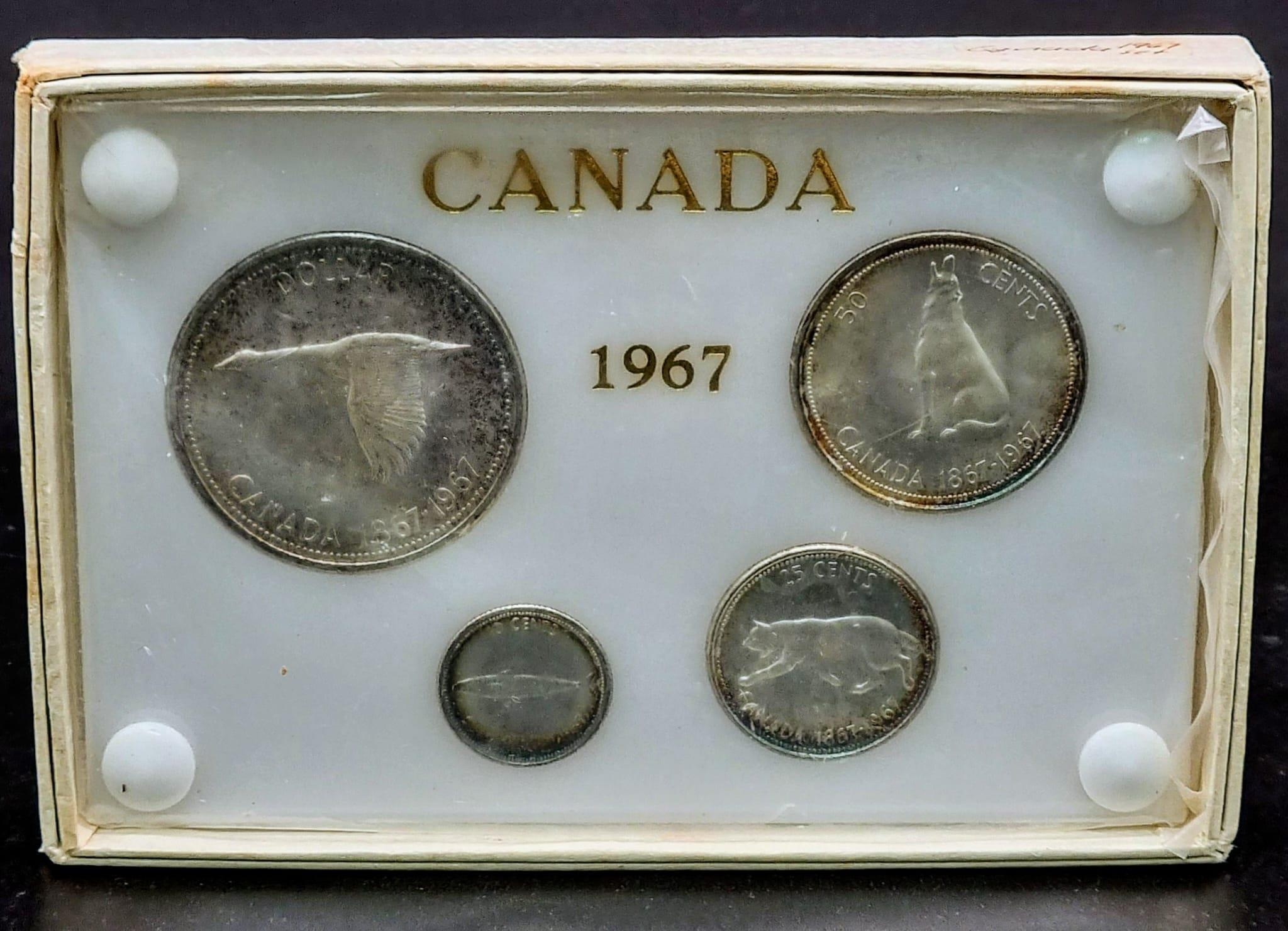 A Boxed Canadian 1967 silver set of coins consisting of 10, 25 and 50 cents and a one Dollar coin,